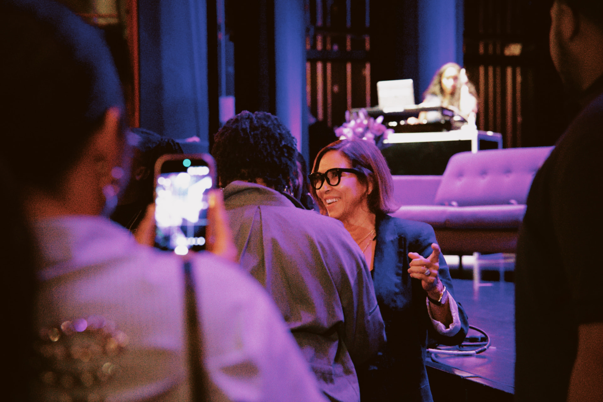 Guests mingling in purple light at the ViewerCon 2026 after party