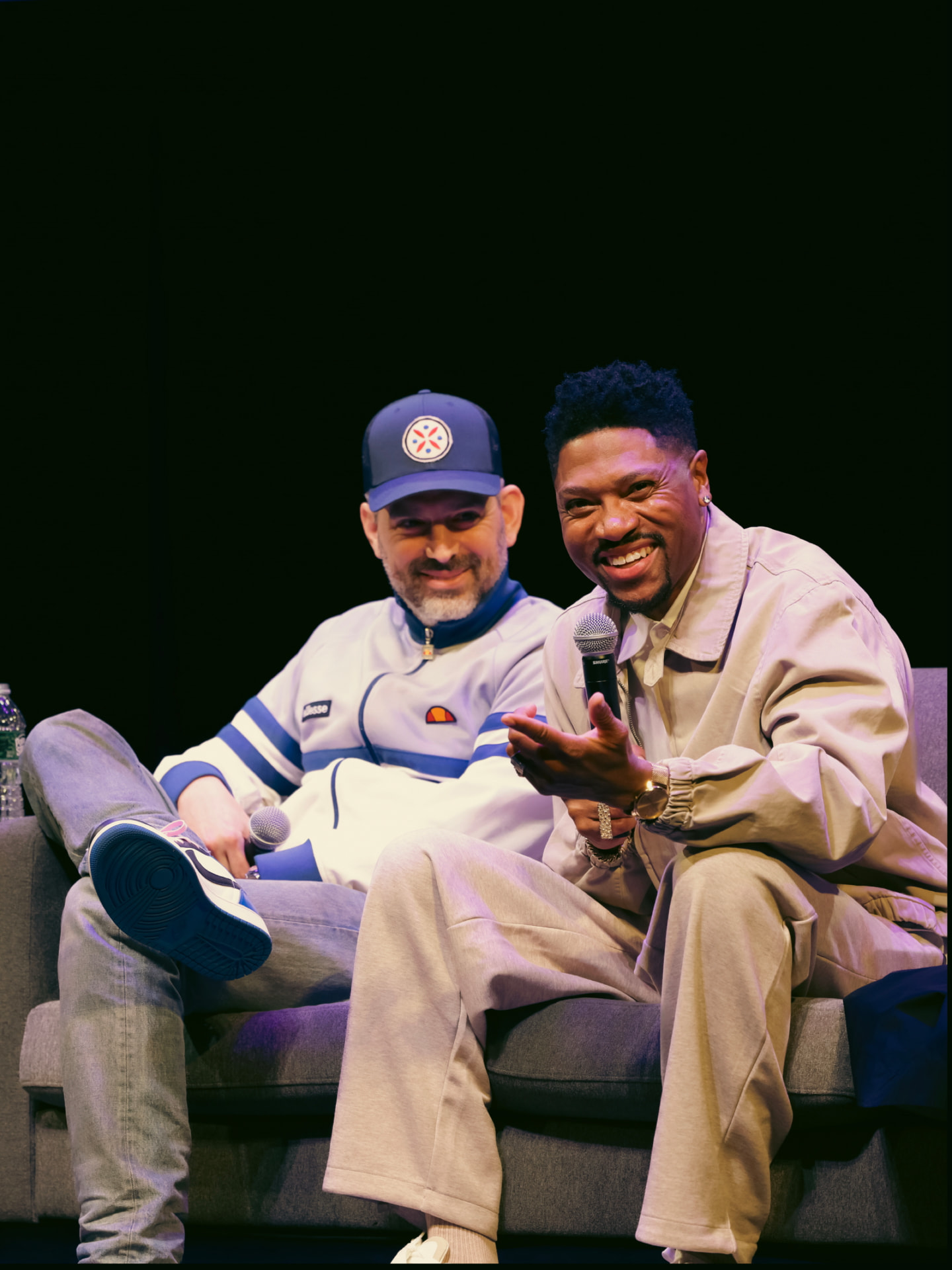 Two panelists laughing together on the couch at ViewerCon 2026