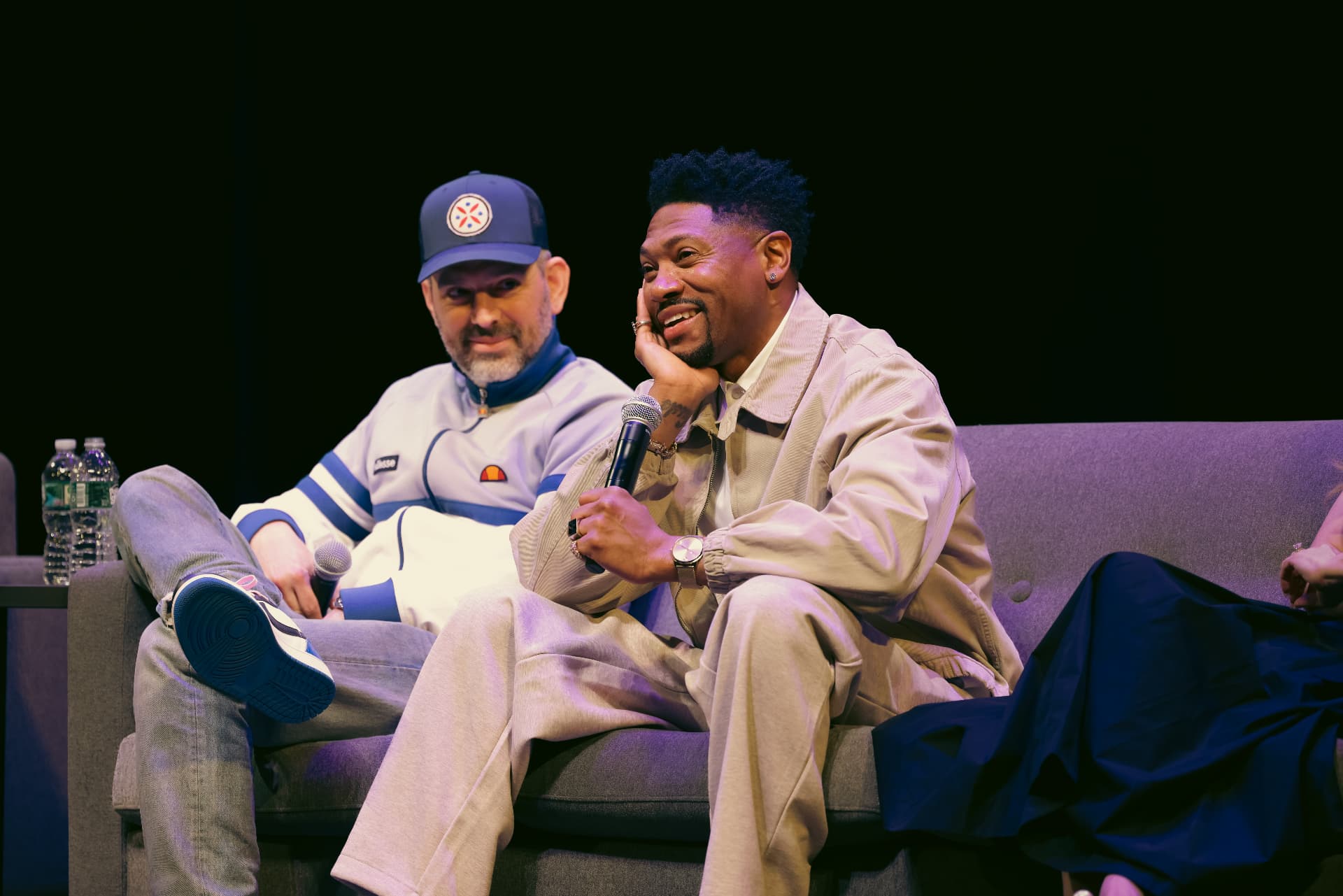 Two panelists laughing during a ViewerCon session