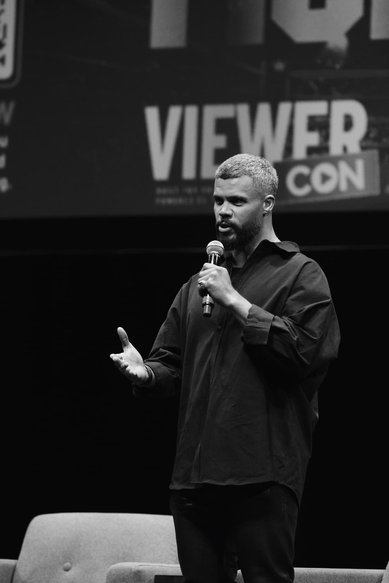 Speaker addressing the crowd in front of the ViewerCon screen