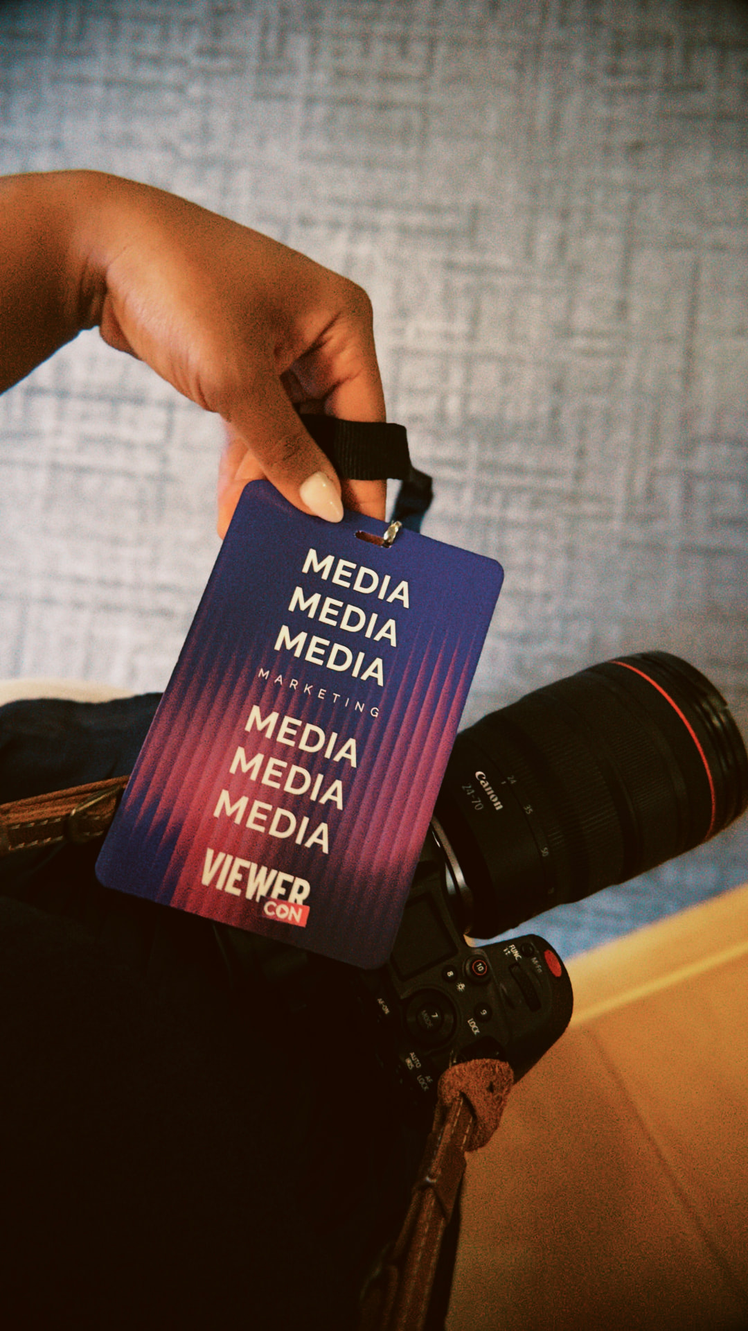 ViewerCon 2026 media pass held above a camera